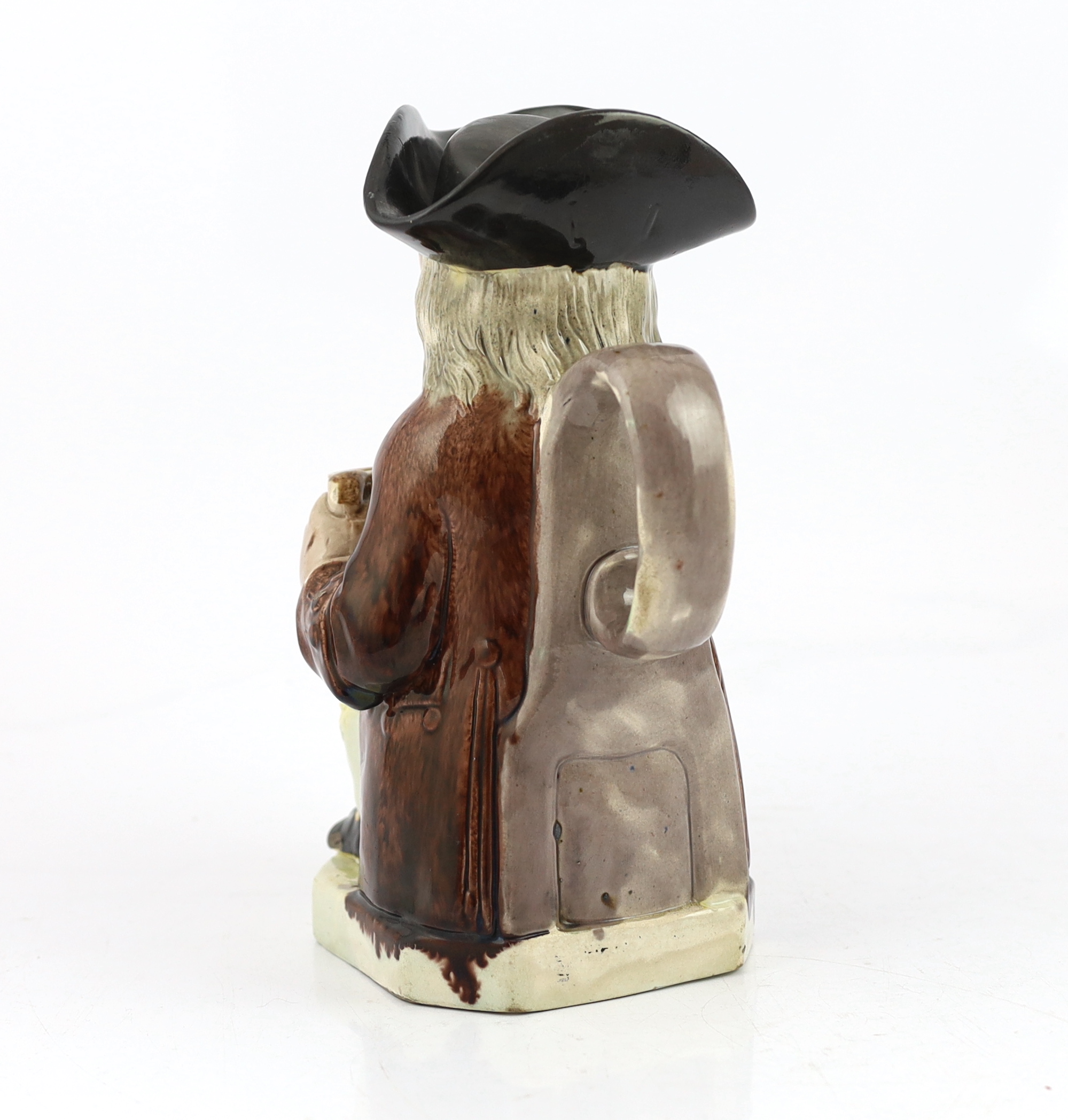 A Ralph Wood type creamware Toby jug of standard type, c.1790, glaze losses and some retouching to the enamels